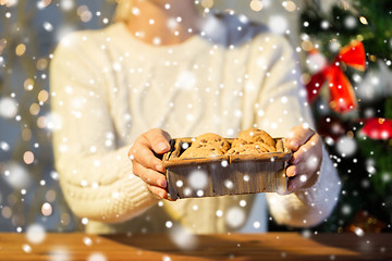 Image showing close up of woman with oat cookies at home