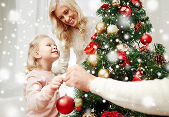 Image showing happy family decorating christmas tree at home