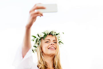 Image showing happy young woman taking smartphone selfie