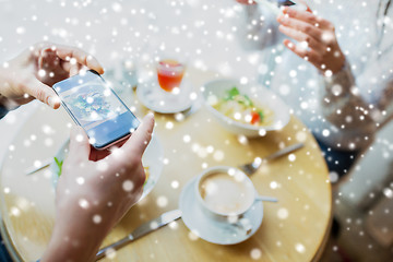 Image showing close up of couple picturing food by smartphone