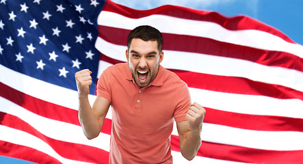 Image showing angry man showing fists over american flag