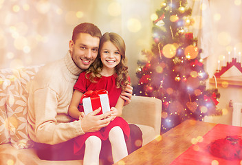 Image showing smiling father and daughter holding gift box