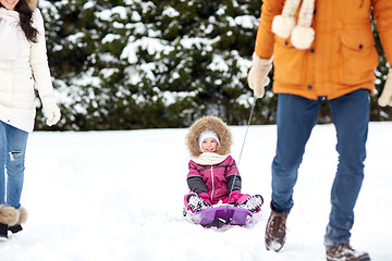 Image showing happy family with sled walking in winter forest