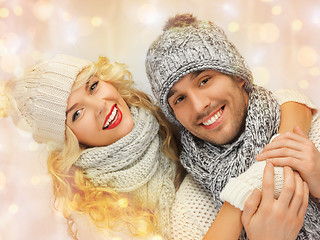 Image showing happy family couple in winter clothes hugging