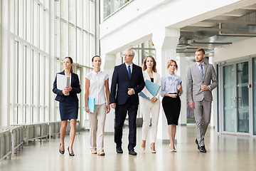 Image showing business people walking along office building