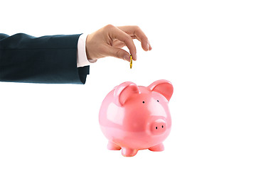 Image showing Piggy bank and hand with coin