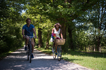 Image showing Young multiethnic couple having a bike ride in nature