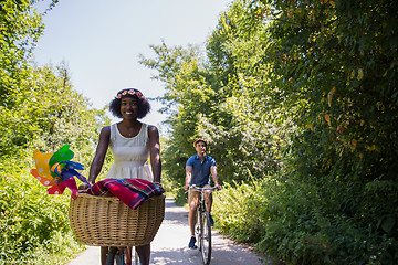 Image showing Young multiethnic couple having a bike ride in nature