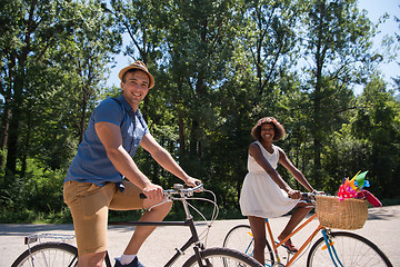 Image showing Young multiethnic couple having a bike ride in nature