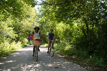 Image showing Young multiethnic couple having a bike ride in nature