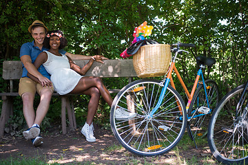 Image showing Young multiethnic couple having a bike ride in nature