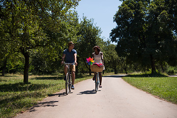 Image showing Young multiethnic couple having a bike ride in nature