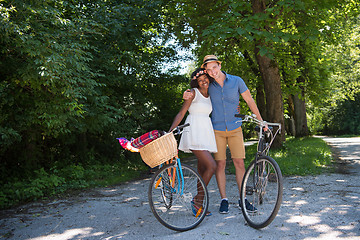 Image showing Young multiethnic couple having a bike ride in nature