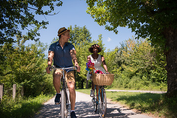 Image showing Young multiethnic couple having a bike ride in nature