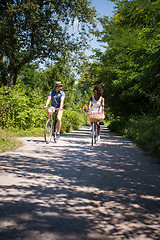 Image showing Young multiethnic couple having a bike ride in nature