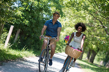 Image showing Young multiethnic couple having a bike ride in nature