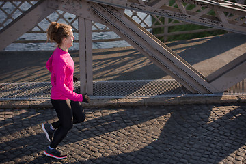 Image showing sporty woman jogging on morning