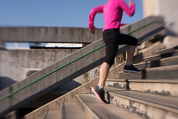 Image showing woman jogging on  steps