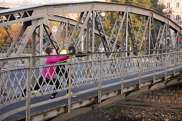 Image showing couple warming up before jogging