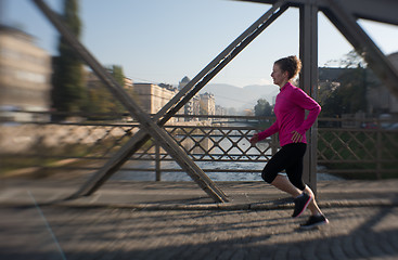 Image showing sporty woman jogging on morning