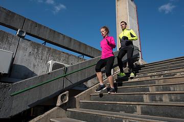 Image showing young  couple jogging on steps