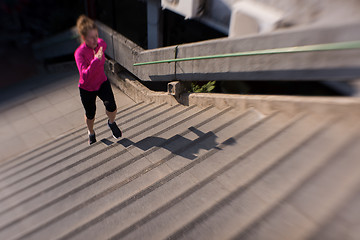 Image showing woman jogging on  steps