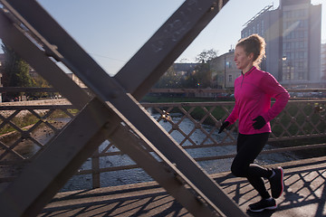 Image showing sporty woman jogging on morning