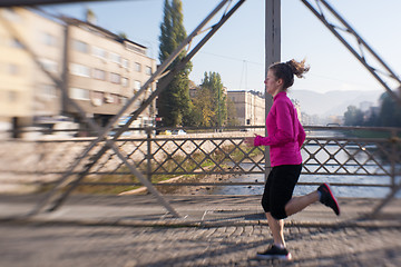 Image showing sporty woman jogging on morning