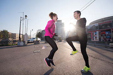 Image showing couple warming up before jogging