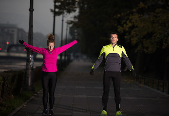 Image showing couple warming up before jogging