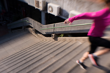 Image showing woman jogging on  steps