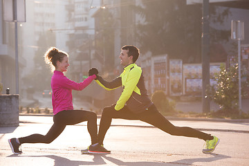 Image showing couple warming up before jogging