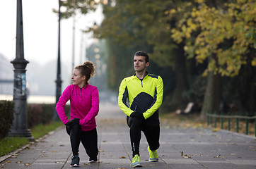 Image showing couple warming up before jogging