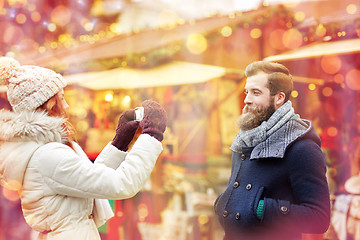 Image showing couple taking selfie with smartphone in old town