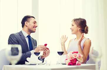 Image showing man proposing to his girlfriend at restaurant