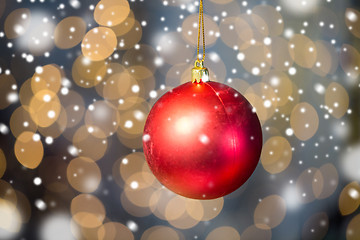 Image showing close up of red christmas ball over golden lights