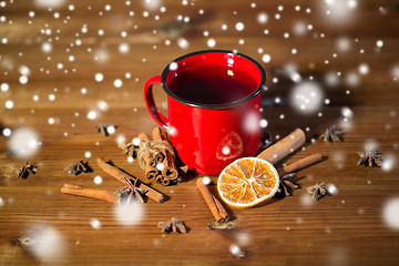 Image showing close up of tea cup with spices on wooden table