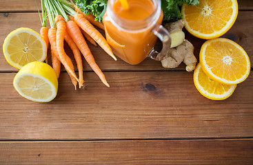 Image showing glass jug of carrot juice, fruits and vegetables