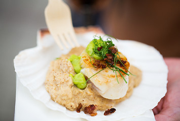 Image showing close up of scallop snack with garnish on seashell