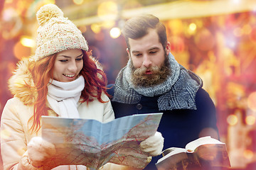 Image showing happy couple with map and city guide in old town