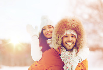 Image showing happy couple having fun over winter background
