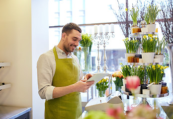 Image showing man with tablet pc computer at flower shop