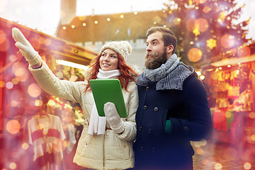 Image showing happy couple walking with tablet pc in old town