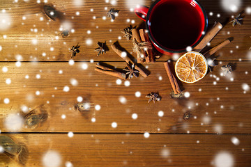 Image showing tea cup with winter spices on wooden table