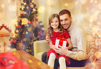 Image showing smiling father and daughter holding gift box