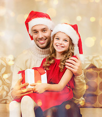 Image showing smiling father and daughter holding gift box