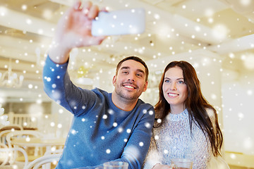 Image showing couple taking smartphone selfie at cafe restaurant