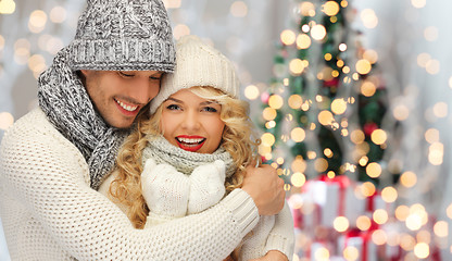 Image showing happy family couple in winter clothes hugging