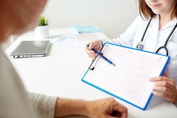 Image showing senior man and doctor with cardiogram at hospital