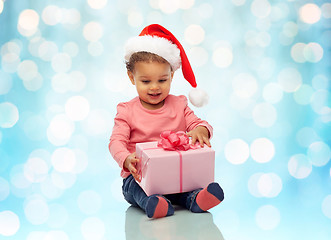 Image showing happy little baby girl with christmas present